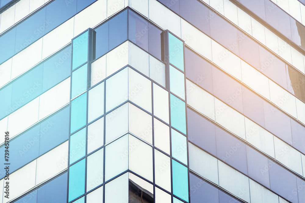 Architectural detail. Geometric abstract background of windows and reflections at sunset. Cool tones with warm sunlight Architectural detail. Geometric abstract background of windows and reflections at sunset. Cool tones with warm sunlight