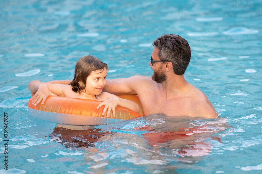 Father and son have fun in swimming pool. Fathers day. Father and son in poolside, summer family. Child with dad playing in swimming pool. Family in pool. Summer vacation. Pool kids party.