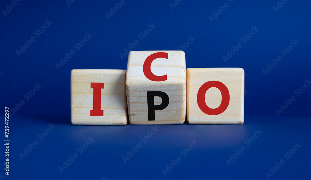 ICO and IPO symbol. Wooden cubes with words ICO - initial coin offering and IPO - initial public offering. Beautiful deep blue background. Business concept. Copy space ICO and IPO symbol. Wooden cubes with words ICO - initial coin offering and IPO - initial public offering. Beautiful deep blue background. Business concept. Copy space