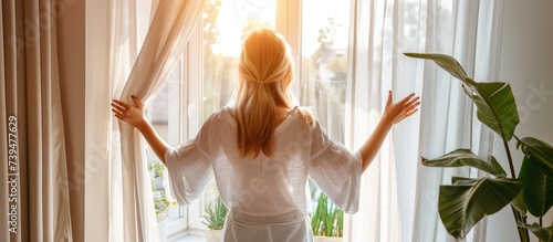Rear view portrait woman open white curtains at the window in morning with sunlight. AI generated photo
