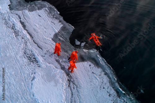 Tourists enjoy floating in dry survival suit in the middle of Arctic Sea. photo