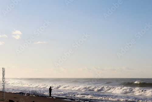 morning on Mahmutlar beach in Turkey. sea ​​with waves. man fishing