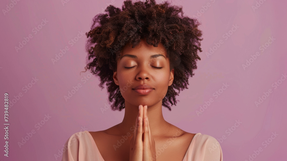 A woman in a serene pose with eyes closed and hands gently raised in a peaceful setting.