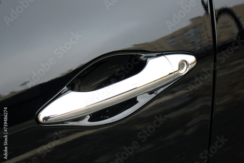 Car door handle. Exterior chrome car door handle with keyless entry button. Keyless entry car door handle with keyless go touch sensor. Automatic opening of a car door without a key.