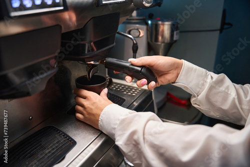 Barista prepares coffee in a coffee machine