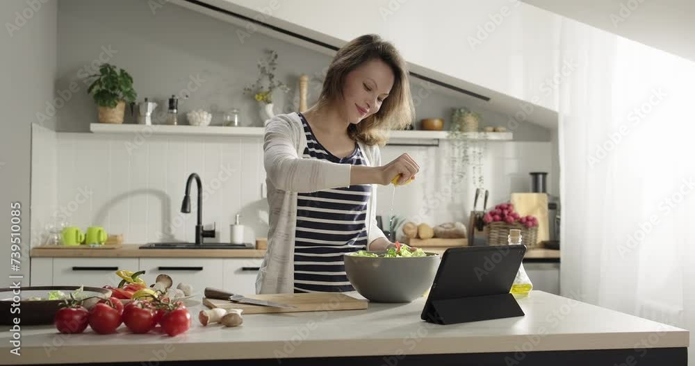 Woman squeezing fresh lemon juice on salad. Cooking healthy vegan food at home. Salad dressing. Weight losing food preparation. Healthy lifestyle Woman squeezing fresh lemon juice on salad. Cooking healthy vegan food at home. Salad dressing. Weight losing food preparation. Healthy lifestyle