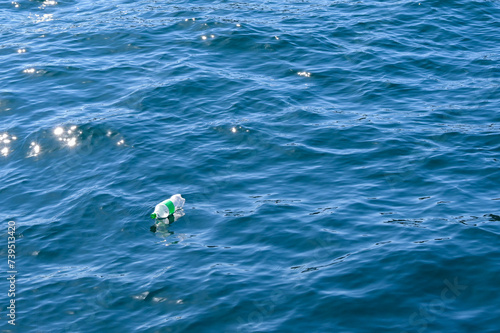 Empty plastic water bottle floating out at sea