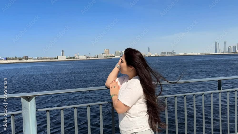 Smiling woman in sunglasses enjoying sights in a modern cityscape setting, indicating leisure travel and urban exploration. High quality 4k footage Smiling woman in sunglasses enjoying sights in a modern cityscape setting, indicating leisure travel and urban exploration. High quality 4k footage