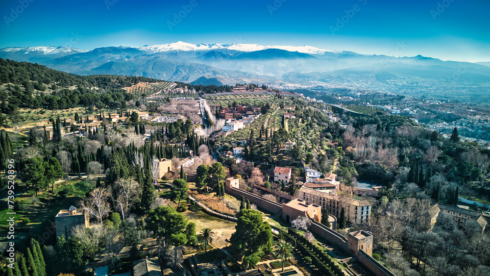 Drone shot of the Alhambra in Granada with the snowy mountains in the background