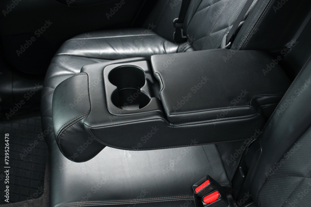 Armrest in premium car with cup holder for rear seats row. Car Leather Seats and rear passengers Armrest.