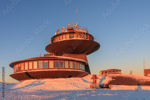 Winter, sunrise time,  disc shaped meteorological observatory in snezka, mountain on the border between Czech Republic and Poland. photo