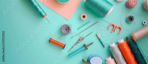 threads and sewing accessories on color background photo