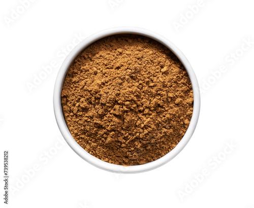 cinnamon powder in a ceramic bowl isolated on a white background, top view.