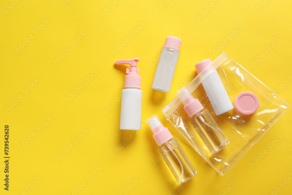 Plastic bag with cosmetic travel kit on yellow background, flat lay. Space for text - obrazy, fototapety, plakaty 