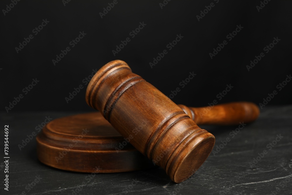 Wooden gavel on dark textured table, closeup Wooden gavel on dark textured table, closeup