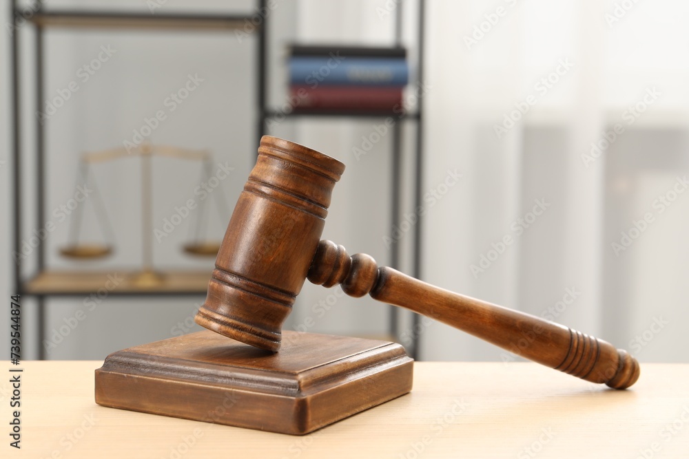 Wooden gavel and sound block on table indoors, closeup Wooden gavel and sound block on table indoors, closeup