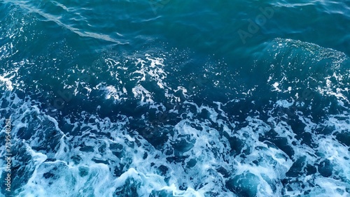 White foam on the blue sea surface.. photo