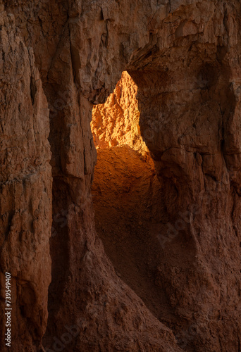 Bright Light Fills the Tunnel Through A Hoodoo In Bryce