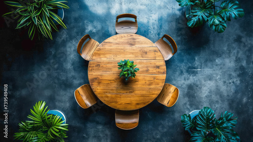 Aerial view of a round wooden table surrounded by plants in a dark office space. Generative AI photo