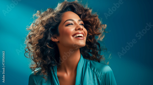 Smiling young woman standing against color background © zebronit