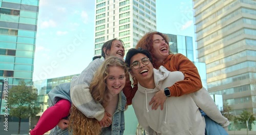 Group of young teenagers having fun hugging in a city. Community and unity concept