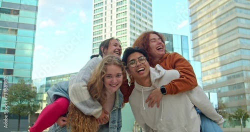Group of young teenagers having fun hugging in a city. Community and unity concept photo