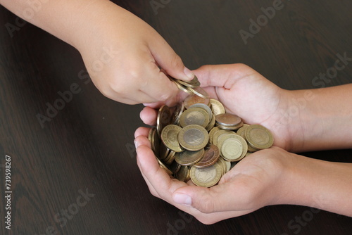 Turkish coins in the child's palm. accumulation and savings.