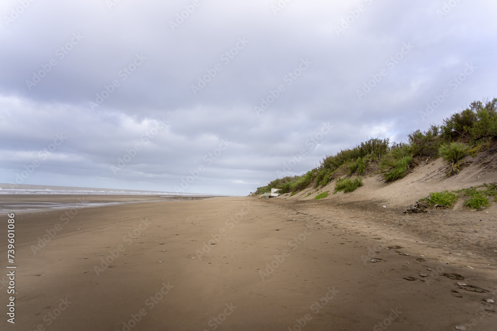Quiet Beach with Gentle Waves and Overcast Sky Quiet Beach with Gentle Waves and Overcast Sky