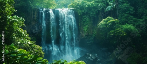 Majestic waterfall flowing down in lush green jungle paradise, serene nature landscape