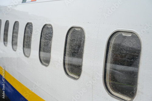 Windows on a plane at an airport. Exterior of jet airplane. 