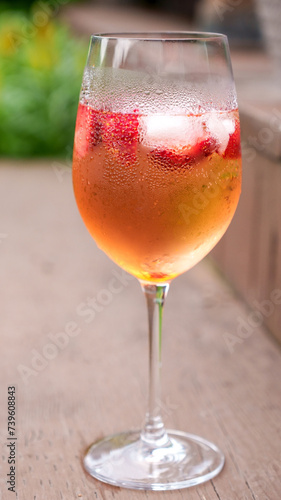 Fresh summer cocktail with strawberry and ice cubes. Glass of strawberry soda drink on dark background. Fresh strawberry cocktail.