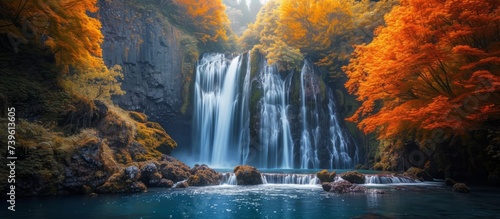 Majestic waterfall cascading down a rocky cliff in a serene natural setting