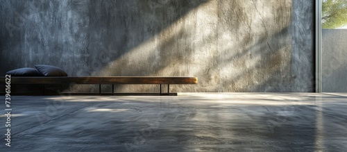 A wooden bench sits in the center of the room, surrounded by a natural landscape of trees and plants. Outside, an asphalt road leads to a nearby lake