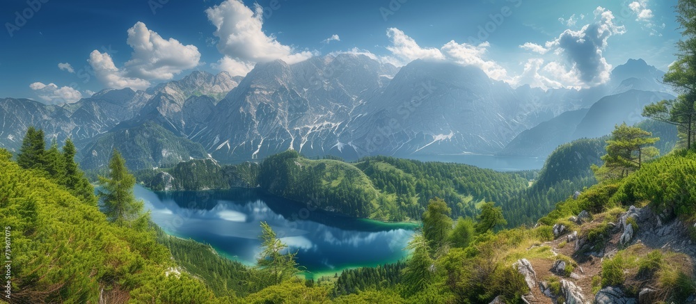 A picturesque natural landscape with a lake nestled in the mountains, surrounded by trees and grass. The sky is filled with fluffy cumulus clouds, creating a serene and peaceful horizon
