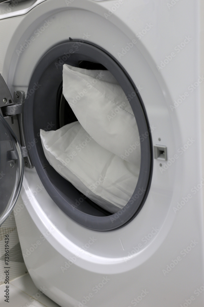 White pillow in washing machine. White pillow in washing machine.