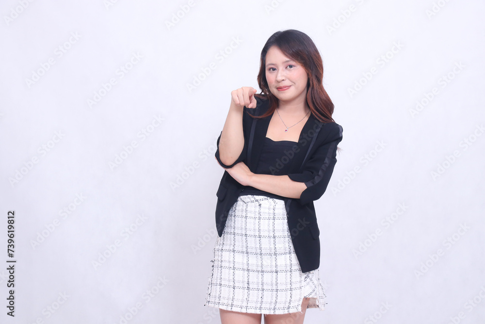 Beautiful Asian Indonesian girl in her 20s in the office smiling gracefully with arms crossed and pointing at the camera isolated on a white background smile Beautiful Asian Indonesian girl in her 20s in the office smiling gracefully with arms crossed and pointing at the camera isolated on a white background smile