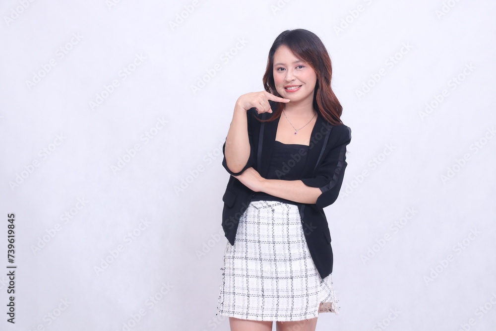 Beautiful Asian Indonesian girl in her 20s in the office cheerful smile arms crossed and pointing to the left isolated on white background Beautiful Asian Indonesian girl in her 20s in the office cheerful smile arms crossed and pointing to the left isolated on white background