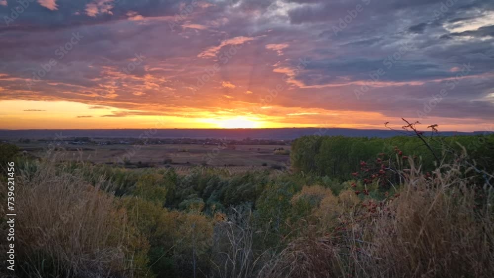 Autumn evening over the valley. Beautiful view to the multicolored forest and orange october sunset. Picturesque fall season scenery Autumn evening over the valley. Beautiful view to the multicolored forest and orange october sunset. Picturesque fall season scenery