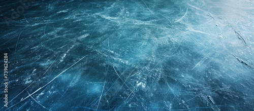 A closeup of a vast electric blue ice rink glistening with lots of frozen water, resembling a mesmerizing underwater pattern in the darkness