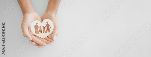 hands holding paper family cutout, family home, adoption foster care, homeless support , mental health, homeschooling , cost of living during recession concept
