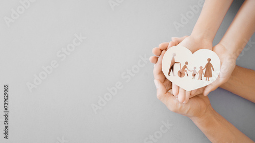 Hands holding diversity family in heart shape, happy carer and volunteer, disable nursing home, rehabilitation and health insurance concept

