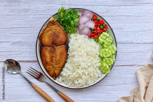 Fried fish with rice and thai style chill sauce with vegetables,top view food