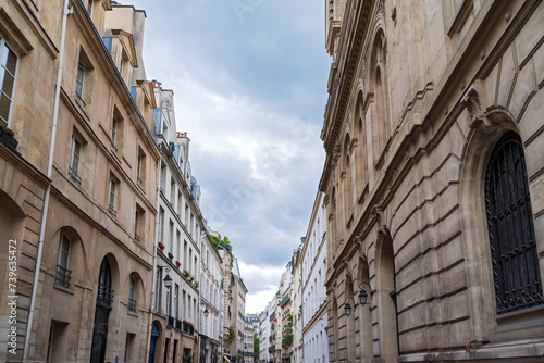 streetscape of commercial and residential buildings along rue des tournelles in marais district paris photo