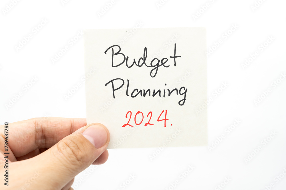 Budget Planning 2024 text message by hand writing on paper note. Budget planning concept. Budget Planning 2024 text message by hand writing on paper note. Budget planning concept.