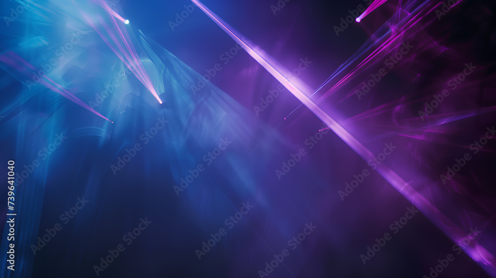 Dynamic blue and purple stage lights cut through theatrical smoke in a dark setting, creating an energetic atmosphere.
