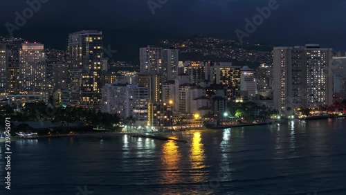 Wallpaper Mural Scenic downtown on tropical island Oahu 4K. Scenic view over Waikiki beach at night. Beautiful Honolulu modern buildings illuminated at night. Drone shot from water of Hawaii largest city after dark Torontodigital.ca