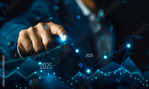 Businessman holding growth graph a year 2025 of business and data analysis. Development to success in year 2025.