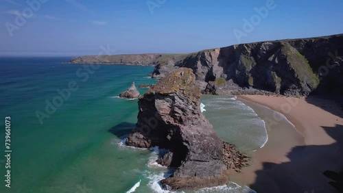 Bedruthan Steps in Cornwall with Rugged Rock Cliffs and Sandy Beaches from an Aerial Drone View. photo