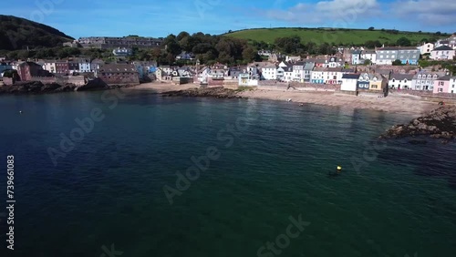 Kingsand Village in Torpoint, Cornwall with an Aerial Drone Dolly Shot Over Calm Waters. photo