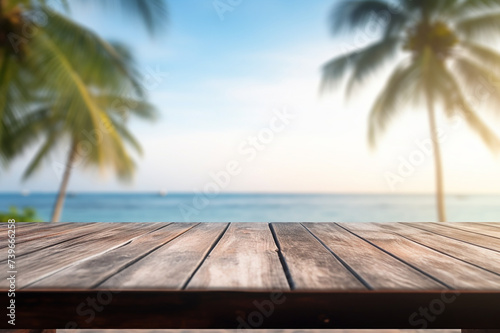 Top of wood table with seascape and palm tree, blur bokeh light of calm sea and sky at tropical beach background. summer vacation background concept.